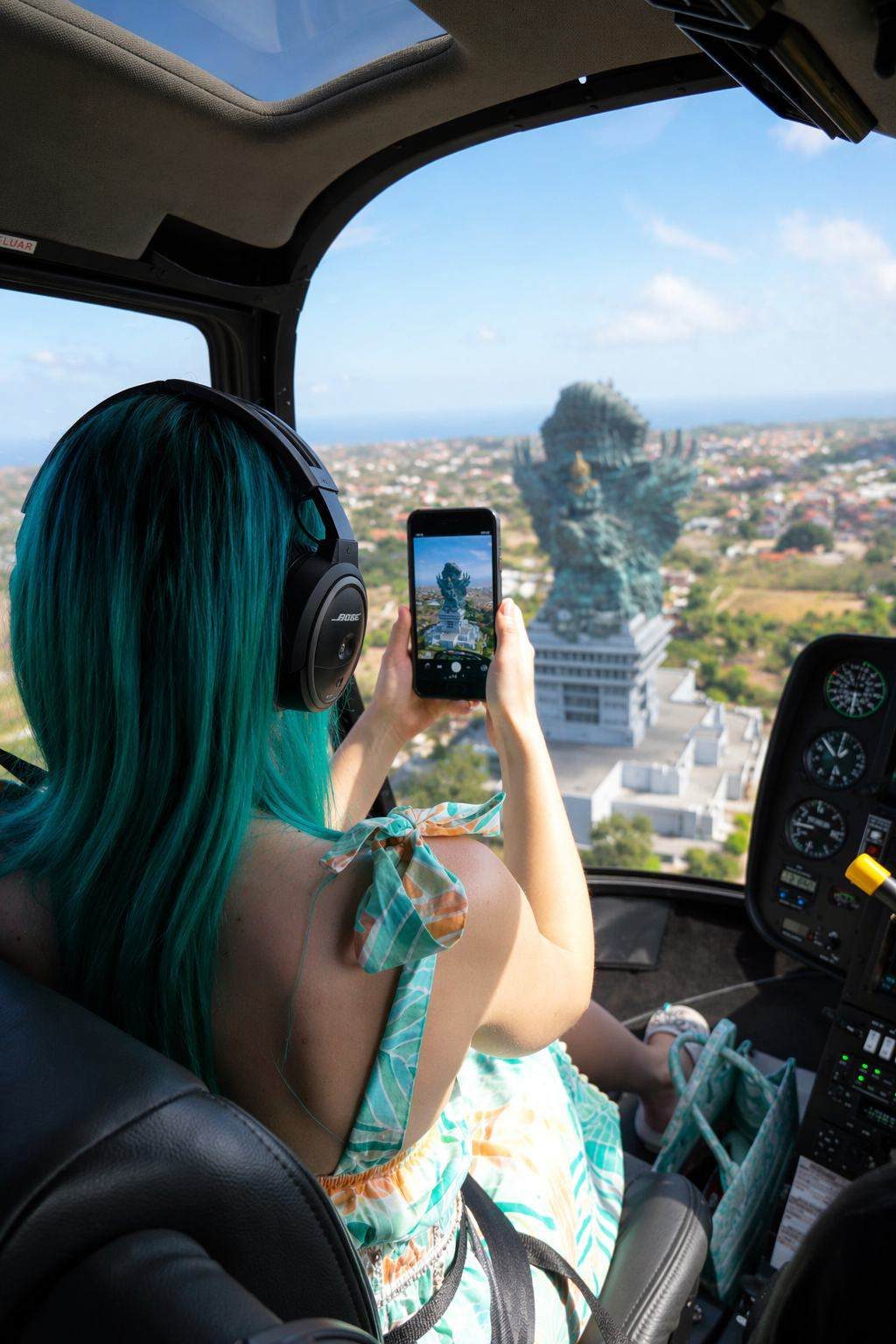 Passenger photographing the GWK statue from the helicopter cabin
