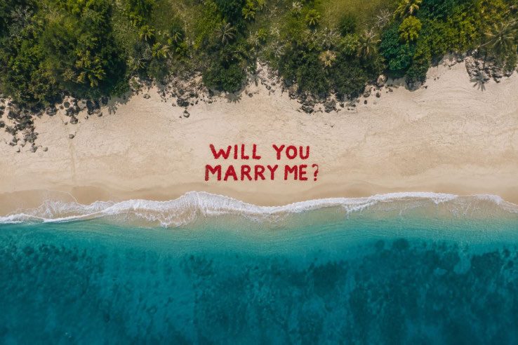 A flower-petal message laid out on the ground, seen from the air