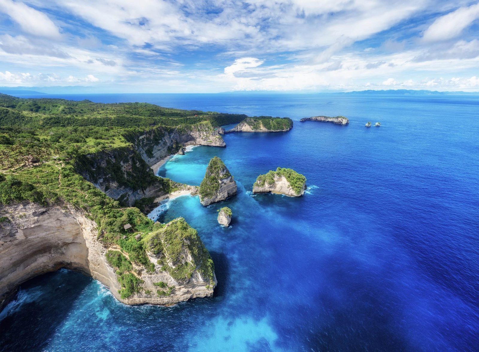 The cliffs and rock islets of Nusa Penida's eastern coast above blue water
